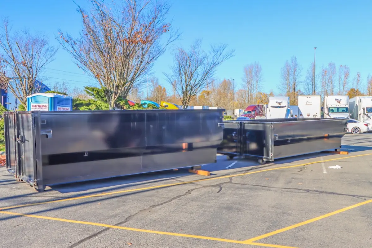 Professional dumpster rental service with roll-off container on residential driveway in Bryan